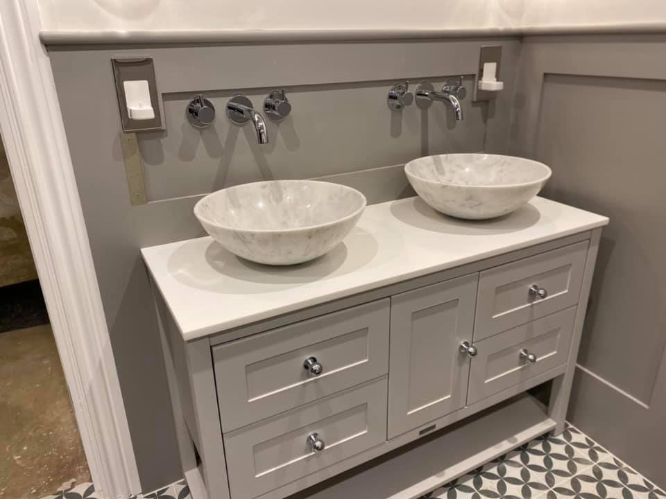 Double vanity unit with two vessel sinks and wall-mounted taps