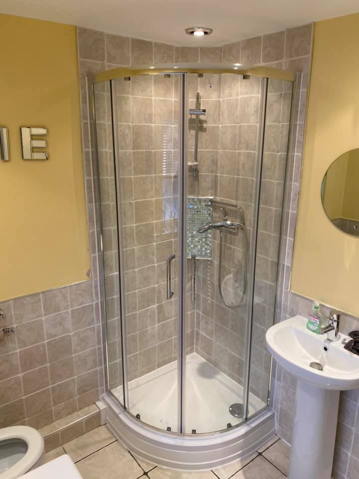 Quadrant shower enclosure with grey tiles